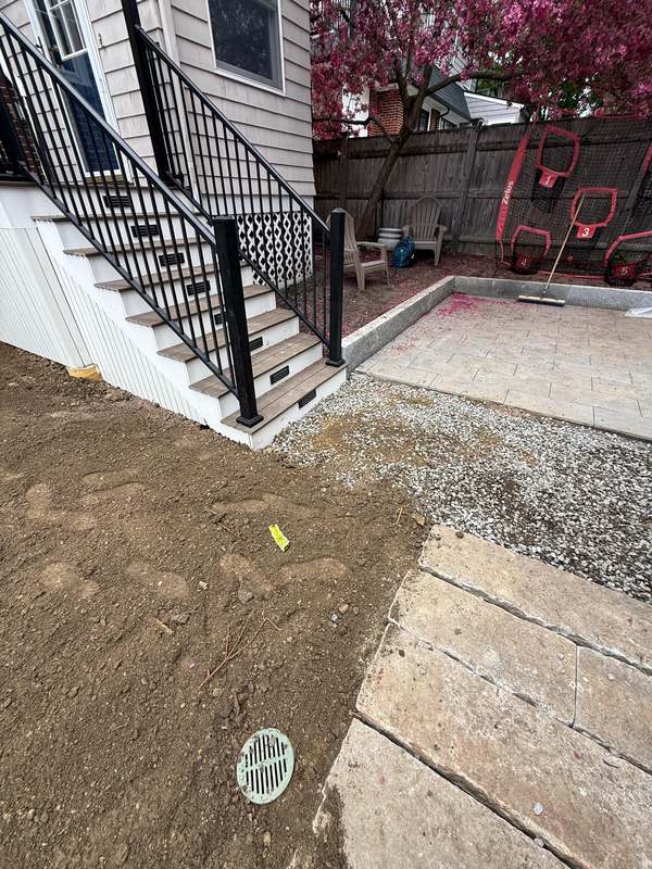 Finished deck staircase with black metal railing